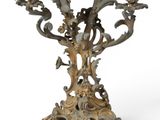 a metal candelab with birds and flowers on it