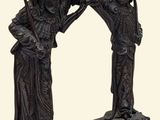 a statue of two women with baskets on their heads