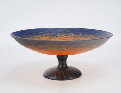 a blue and orange bowl sitting on a black stand