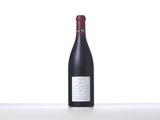 a bottle of red wine sitting on top of a table