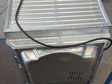 a silver microwave sitting on top of a blue cart