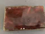 a picture of a small metal box on a table