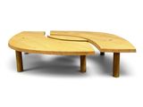 two wooden coffee tables with curved legs and a curved top