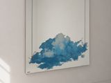 a painting hanging on the wall in a white room