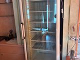 a refrigerator that has a sign on it in a kitchen