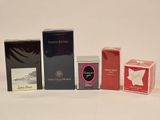 several different types of perfumes are lined up on a white surface