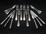 six forks and six knives arranged in a circle on a black background