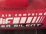 a close up of a red car with a sticker on it