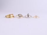 three gold and silver rings on a white background