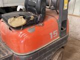 a forklift with a helmet on top of it in a warehouse