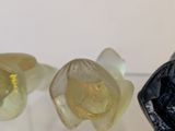 three pieces of glass sitting on top of a glass table