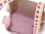 a pink purse with a yellow and brown design on it