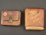 pair of vintage leather wallets with red cross emblem on them