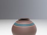 a small brown vase with a blue stripe on it