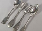 four silver spoons and a fork are lined up on a table