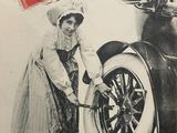 an old advertisement for a car with a woman working on it