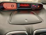 a car dashboard with a digital clock on it