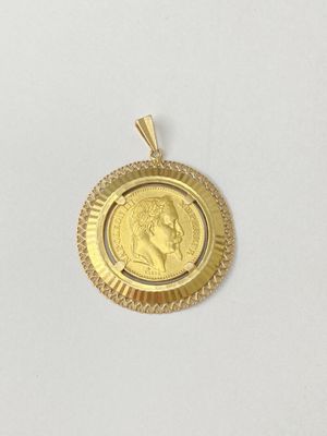 a close up of a gold coin on a white surface