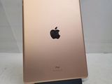 the back of a gold ipad with an apple logo on it