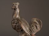 a statue of a rooster that is on a table
