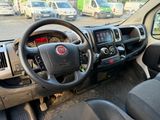 a steering wheel and dashboard of a truck in a parking lot