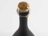 a bottle of liquor with a gold cap on it