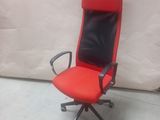 a red office chair with a black leather seat