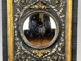 painting of a man and a woman in a mirror on a wooden easel