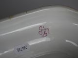 a close up of a white porcelain bowl with red writing on it