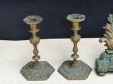 three candlesticks sitting on a table next to each other