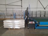 a picture of a warehouse with pallets and a conveyor belt