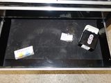 a toothbrush, toothpaste, and toothpaste in a drawer
