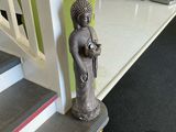 a statue of a person sitting on the stairs