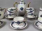 a group of tea and coffee cups and saucers on a table