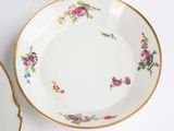 three plates that are sitting on a white table
