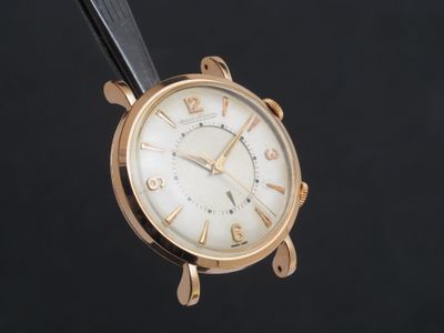une image d'un gros plan d'une montre-bracelet sur un fond noir