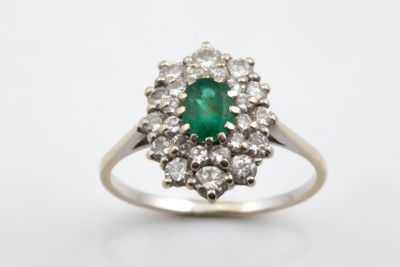 an emerald and diamond cluster ring