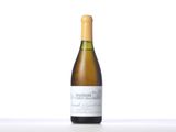 a bottle of white wine sitting on top of a table