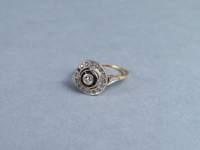 a close up of a gold and diamond ring on a blue surface