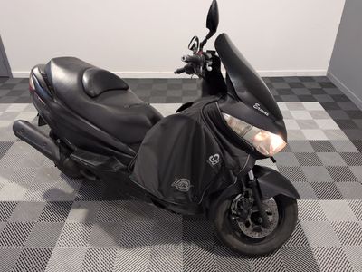 a black motorcycle parked in a room with a checkered floor