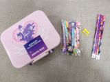 a pink box with a bunch of pencils next to it