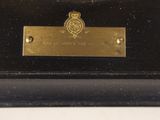an image of a close up of a metal plaque on a table