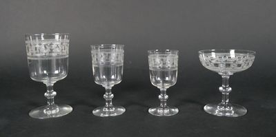 three clear wine glasses sitting next to each other on a table