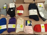 many pairs of socks on a table with price tags on them