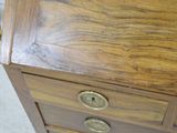 a wooden dresser with brass knobs on it