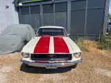 a red and white striped car parked in front of a building
