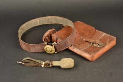 an old leather belt with a brass buckle and a leather case