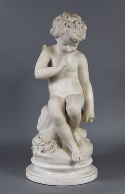 a white marble statue of a boy sitting on a rock