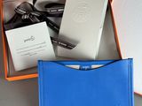 an orange and blue box containing a card case and a blue wallet