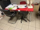 a red table with a fan on top of it